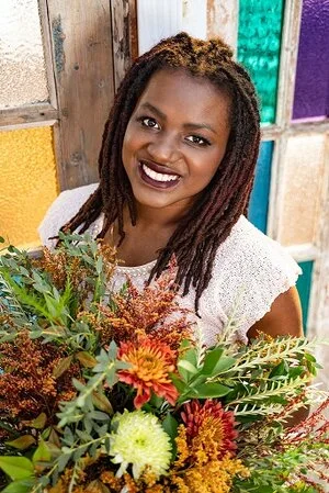 Cillia Marion holding a floral arrangement